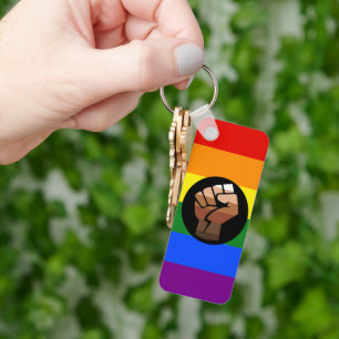 SlipperyJoe's queer people colour flag raised fist Keychain