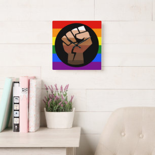 SlipperyJoe's queer people colour flag raised fist Square Wall Clock