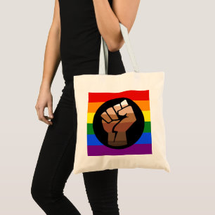 SlipperyJoe's queer people colour flag raised fist Tote Bag