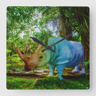 SlipperyJoe's rhinoceros lush tropical setting pri Square Wall Clock