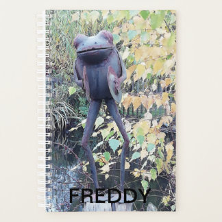 Small ornamental statue of a frog. planner