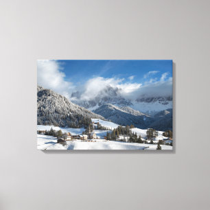 Small village with Dolomites mountains in the snow Canvas Print