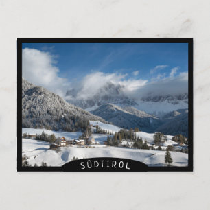 Small village with Dolomites mountains in the snow Postcard