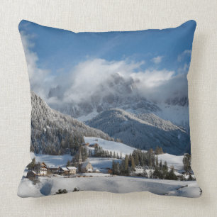 Small village with Dolomites mountains in the snow Throw Pillow