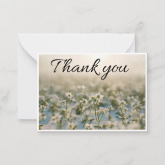 small white flower scattered across thank you card