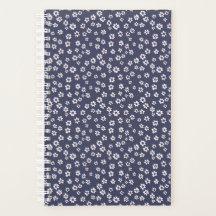 Small white flowers on a blue planner