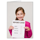 Smiling girl student proud of report card