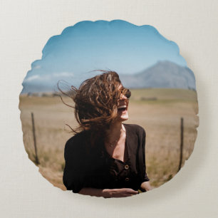 Smiling woman on brown and green field round pillow