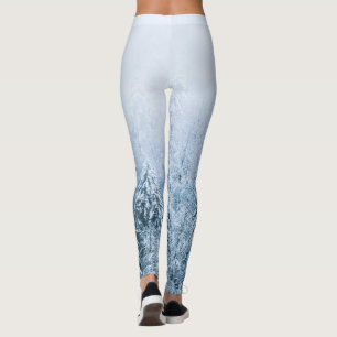 Snow covered beech spruce forest in fog leggings