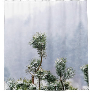SNOW COVERED GREEN LEAF TREE