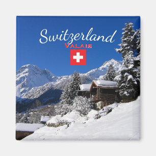 Snow-covered log cabins in Switzerland Magnet