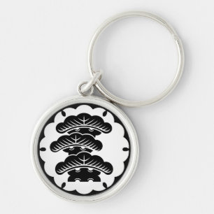 Snow-covered three-tiered pine in rice cake keychain
