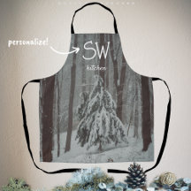 Snow-covered trees in the misty winter forest