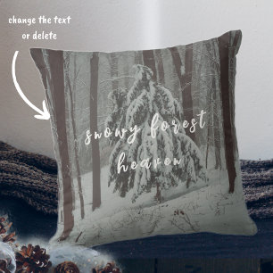 Snow-covered trees in the misty winter forest throw pillow