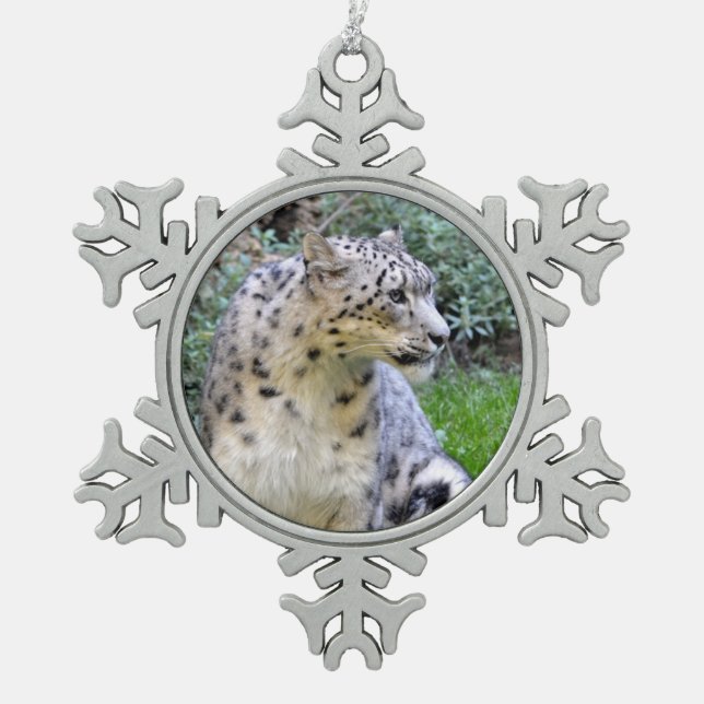Snow leopard sitting on the grass  snowflake pewter christmas ornament (Front)