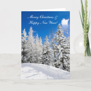 Snow trees under a clear blue sky christmas card