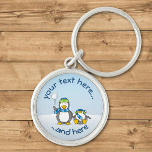 Snowballing penguins keychain