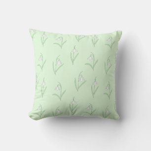 Snowdrops on green background throw pillow