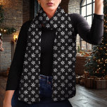 Snowflake Black and White Christmas Scarf<br><div class="desc">Embrace the winter season with this elegant black and white Christmas scarf featuring a delicate snowflake pattern. The timeless black background and contrasting white snowflakes create a chic and versatile look that complements any holiday outfit. Made from lightweight chiffon, this scarf adds a touch of sophistication to your winter wardrobe...</div>