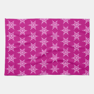 Snowflakes, pale pink crystals on magenta kitchen towel