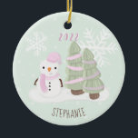 Snowman Christmas Ceramic Ornament<br><div class="desc">Snowman Christmas
Celebrate your child’s winter birthday with this cute and snowman wearing a pastel pink knitted hat and scarf.  This theme is ideal for your little one’s winter birthday or kid’s Christmas party.   Design is completely customizable. Check out the coordinating stationery and gifts.</div>