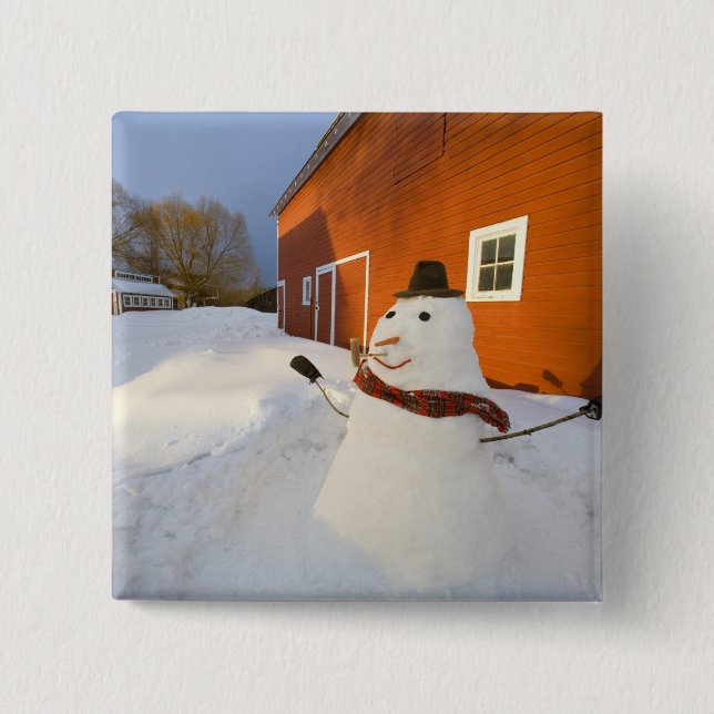 Snowman in front of red barn in Columbia Falls 2 Inch Square Button (Front)