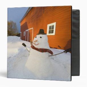 Snowman in front of red barn in Columbia Falls Binder