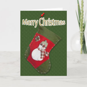 Snowman on Christmas Stocking Over Green Holiday Card