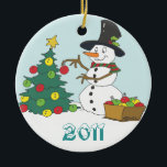 Snowman Trimming Tree Ceramic Ornament<br><div class="desc">This snowman is getting into the Christmas spirit by trimming the tree. Even the biggest Scrooge's heart will be warmed by it. Image and text on both sides. Customize it with your own text.</div>