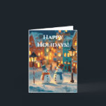 Snowmen in a Magical, Colorful Christmas Village Holiday Card<br><div class="desc">A charming, enchanting photograph capturing two adorable, small snowmen standing together in a snowy street scene. The snowmen are stylized, wearing colorful top hats (teal and orange) and matching scarves (orange and blue), with carrot noses and stick arms. They are illuminated by the warm glow of two old-fashioned street lamps...</div>