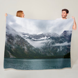 Snowy mountains in the fog at Plansee lake  Fleece Blanket