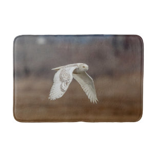 Snowy owl in flight bath mat