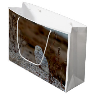 Snowy owl sitting on a rock large gift bag