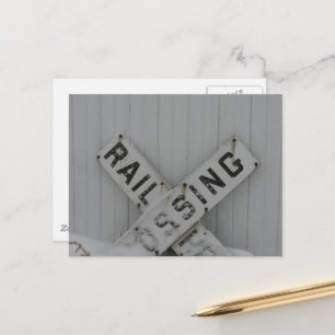 Snowy Rail Crossing Sign in Front of White Barn Postcard