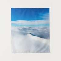 Snowy winter mountain wrapped in clouds