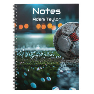 Soccer ball on the empty wet arena pitch notebook