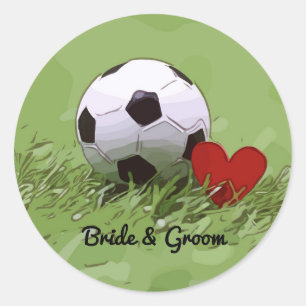 Soccer ball with red heart on green grass wedding classic round sticker