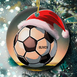 Soccer Ball with Red Santa Hat Name Christmas Ceramic Ornament<br><div class="desc">Soccer Ball with Red Santa Hat Name Christmas Ceramic Ornament. Add your name or erase it. A great Christmas gift for someone who loves soccer.</div>