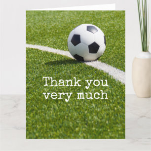 Soccer ball with word Thank you on green grass Card