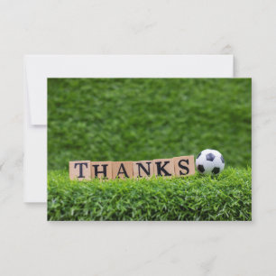 Soccer ball with word Thanks on green grass Postca Thank You Card
