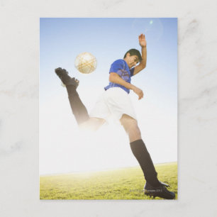 Soccer player jump kicking postcard