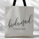 Soft Grey Bridesmaid Modern Script Tote Bag<br><div class="desc">Show your appreciation to your bridal party with this stylish soft grey bridesmaid tote bag. Featuring modern script and customizable with your bridesmaid's name, this tote bag is both practical and elegant. The soft colour and chic design make it perfect for carrying wedding day essentials or everyday items. This personalized...</div>