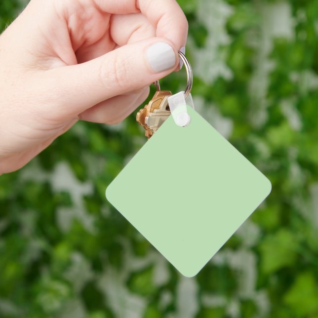 Soft pale green background with subtle vertical keychain (Hand)