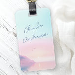 Soft pastel sunrise with birds script name luggage tag<br><div class="desc">Luggage tag featuring your name in a handwritten style script over a soft,  pastel coloured sunrise with a cliffs and two birds on the front. Add your contact information on the back.</div>