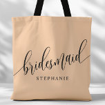 Soft Peach Bridesmaid Modern Script Tote Bag<br><div class="desc">Show your appreciation to your bridal party with this stylish soft peach bridesmaid tote bag. Featuring modern script and customizable with your bridesmaid's name, this tote bag is both practical and elegant. The soft colour and chic design make it perfect for carrying wedding day essentials or everyday items. This personalized...</div>