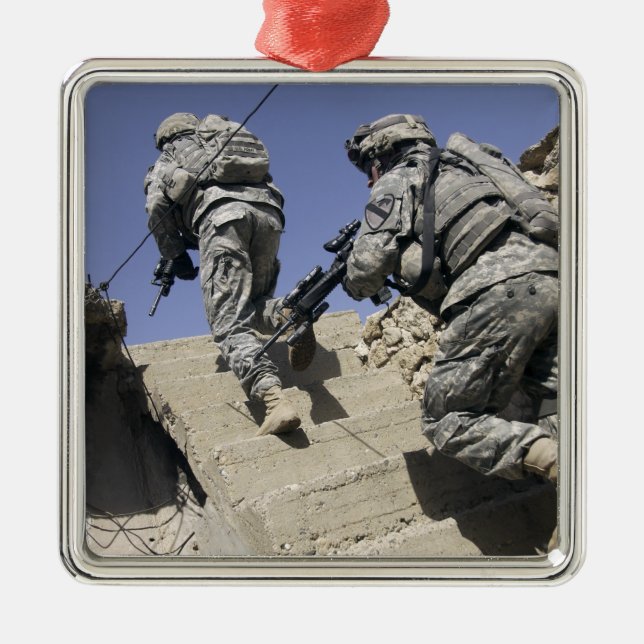 Soldiers running up staircase of a building metal ornament (Front)