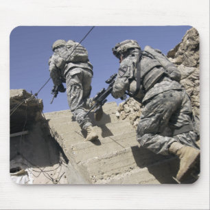 Soldiers running up staircase of a building mouse pad