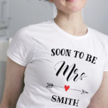 Soon to be Mrs. personalized name T-Shirt<br><div class="desc">Soon to be Mrs. personalized with name for the bride to be. Soon to be in black uppercase letters with Mrs in tall decorative cursive lettering. Embellished with a black doodle arrow and red heart. Personalize with new surname in matching black font.</div>