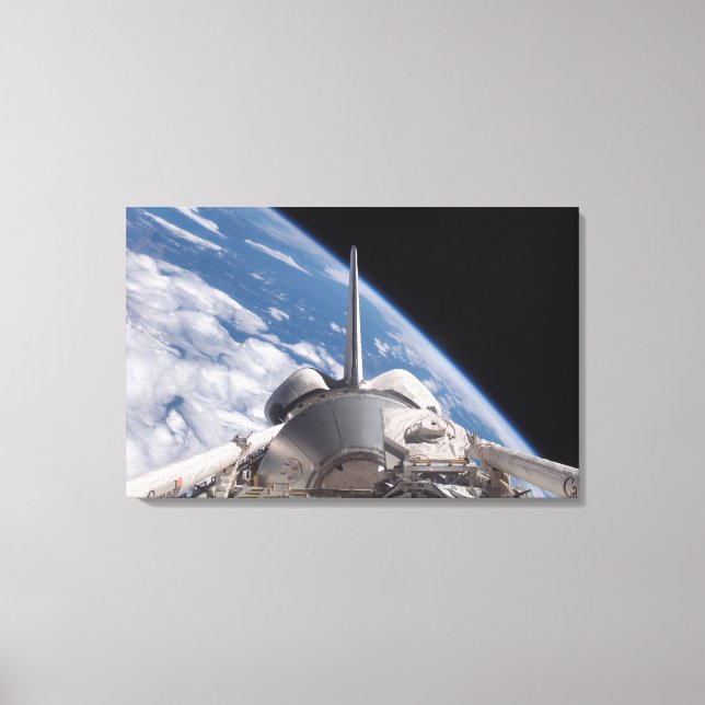 Space Shuttle Discovery backdropped by Earth Canvas Print (Front)
