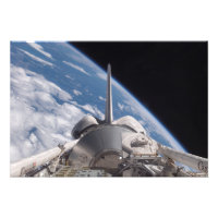 Space Shuttle Discovery backdropped by Earth
